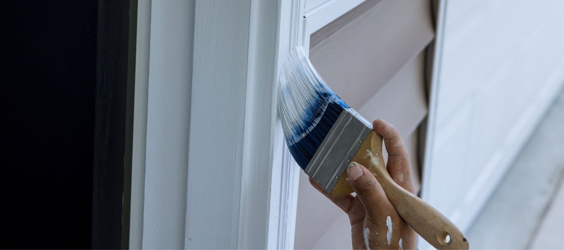 man painting a home