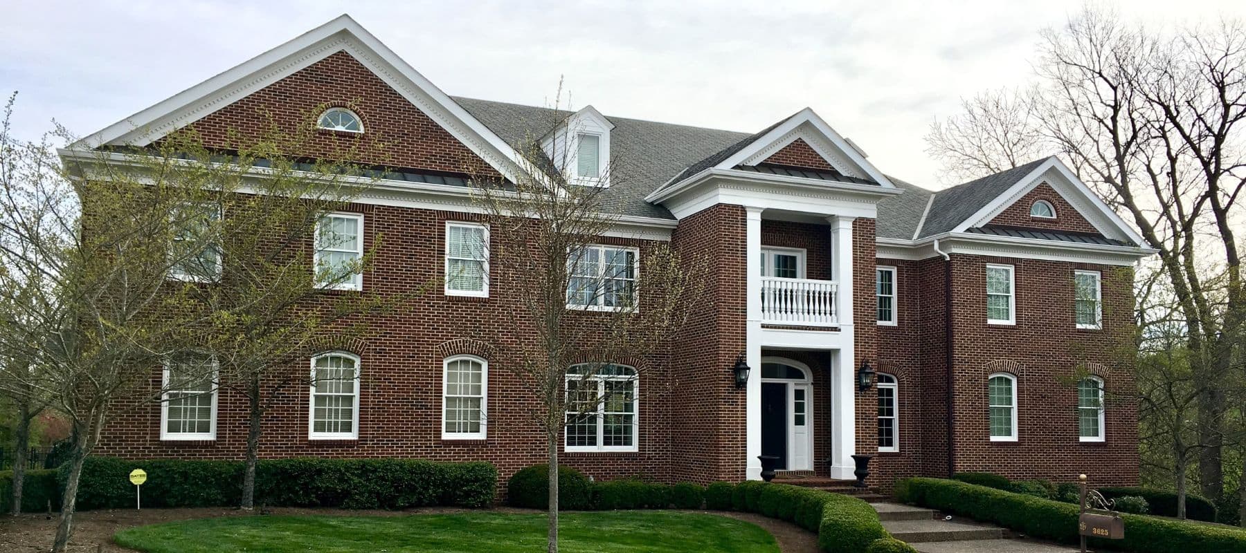 wide angle of large red brick home