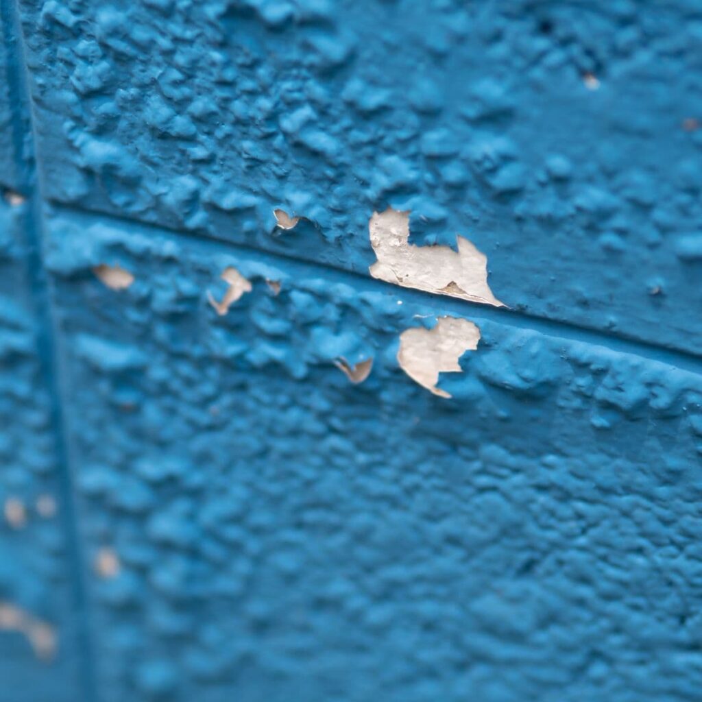paint bubbling on a concrete wall